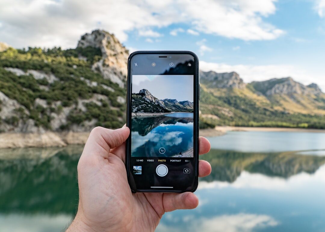 person filming with smartphone