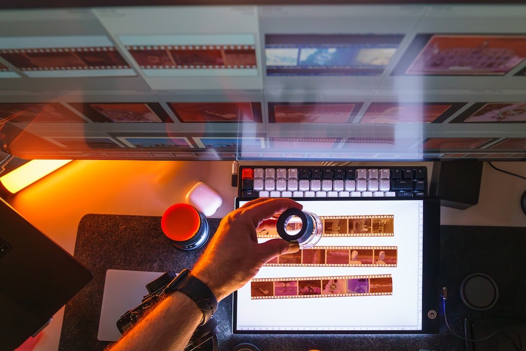Video editor working at a multi-monitor workstation with colour grading software