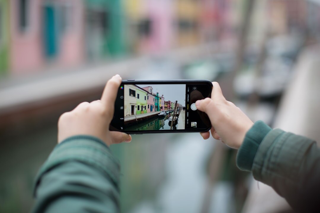 person filming with smartphone